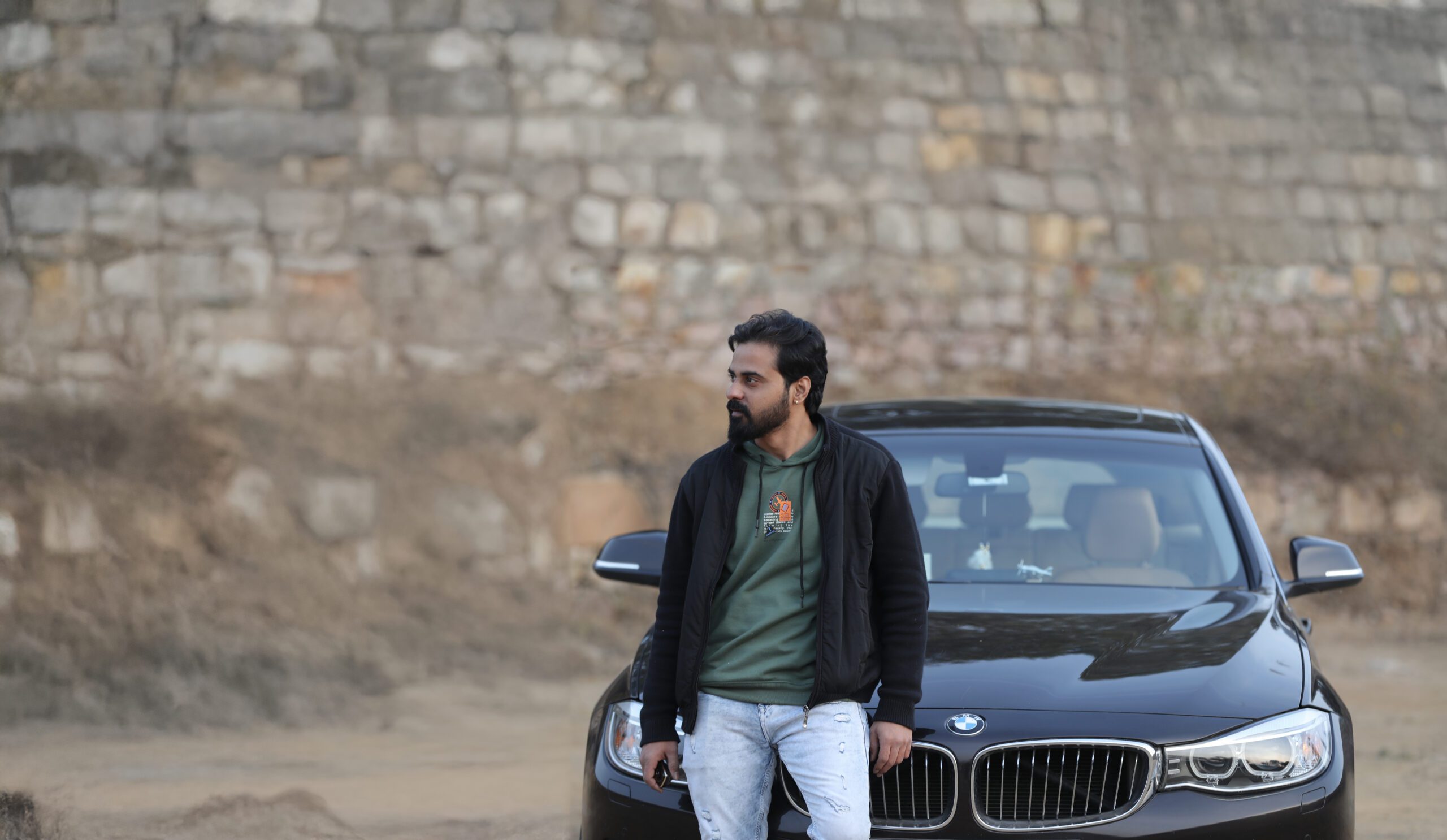 a man standing next to a car
