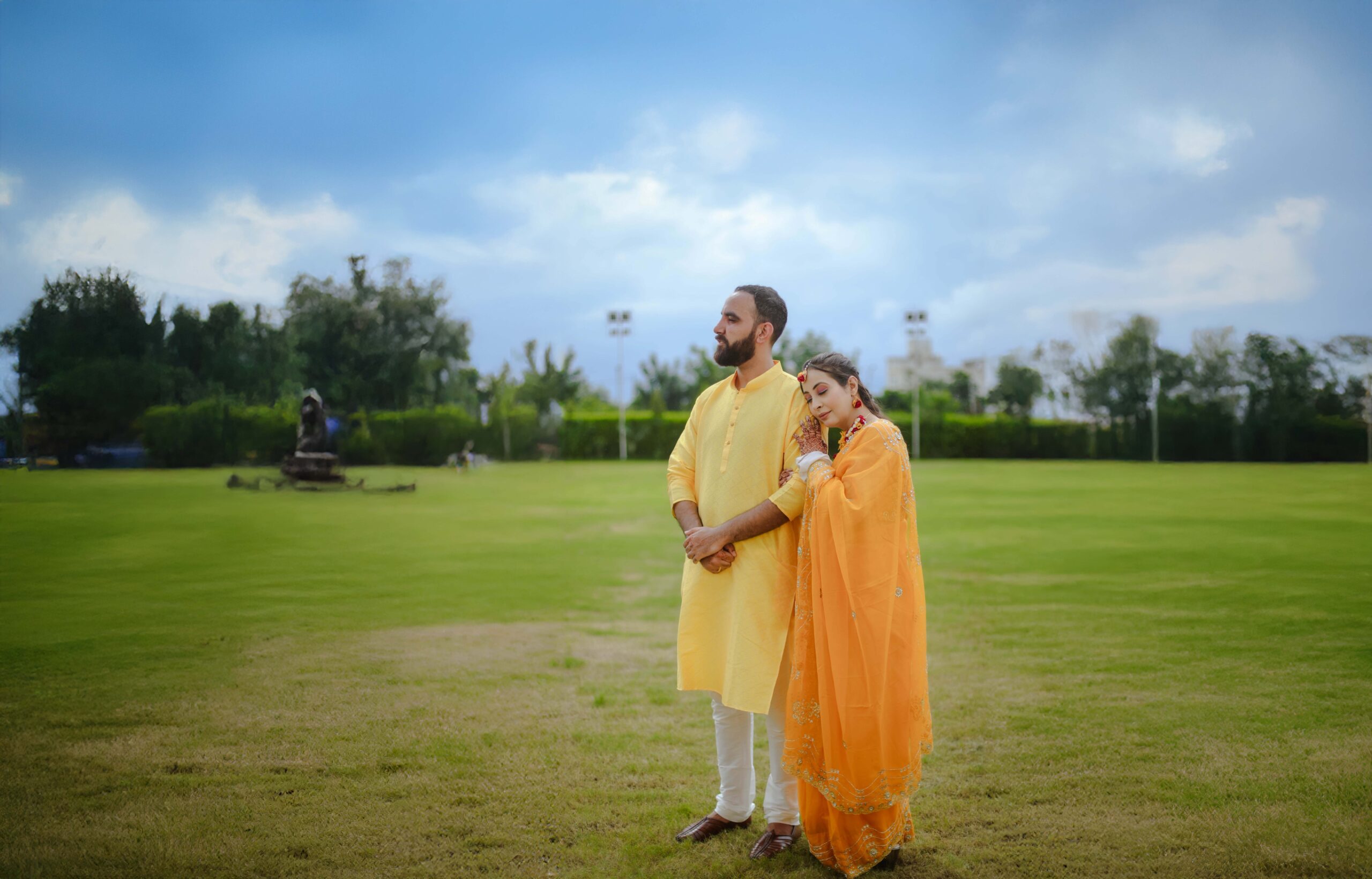a man and woman standing in a field
